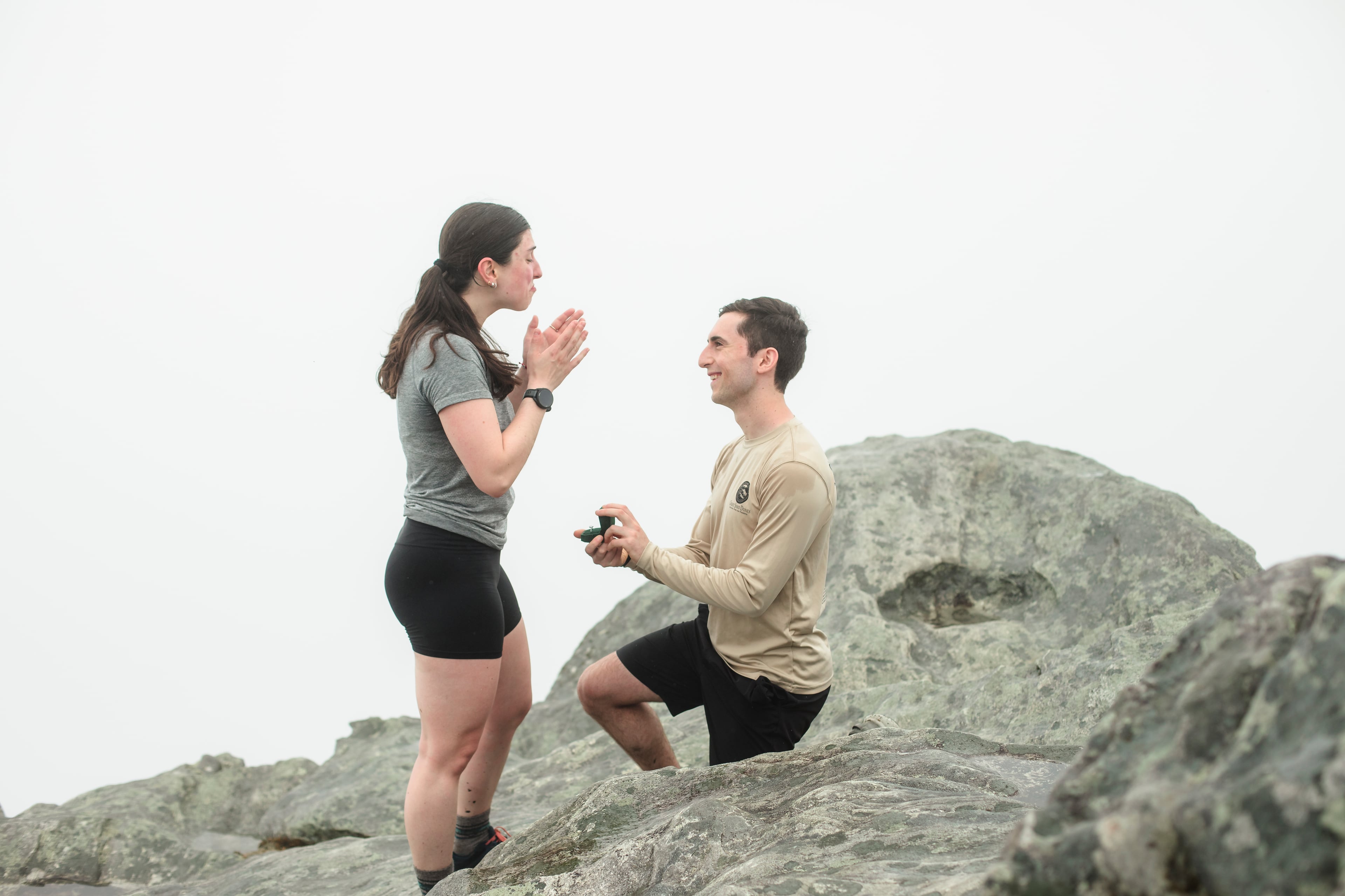 Montana reacting as Ari holds out the ring on the mountaintop